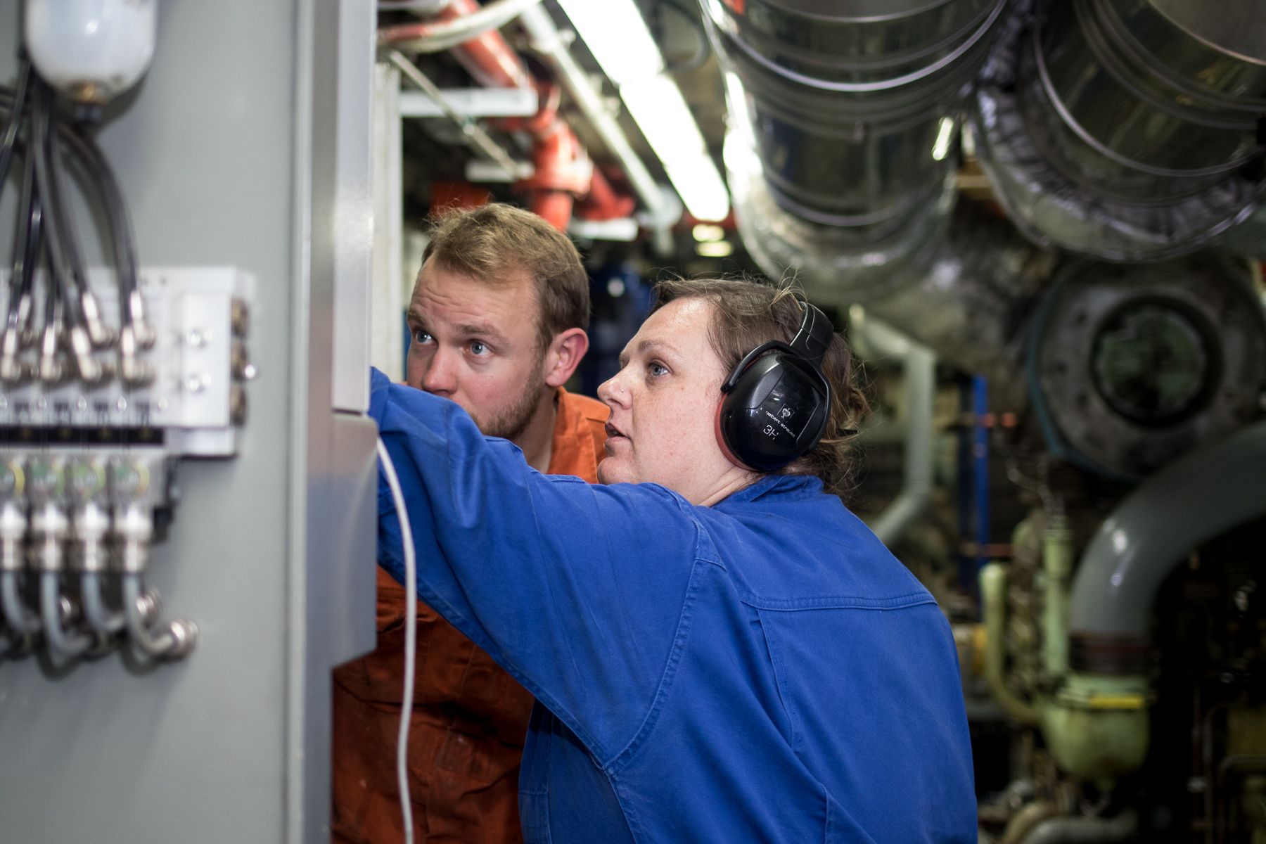 Tenerife, Spain :: Eszter Vanheiden (Hungary) and Thomas Meyer (Switzerland) monitor the machines in Logos Hope's engine room.