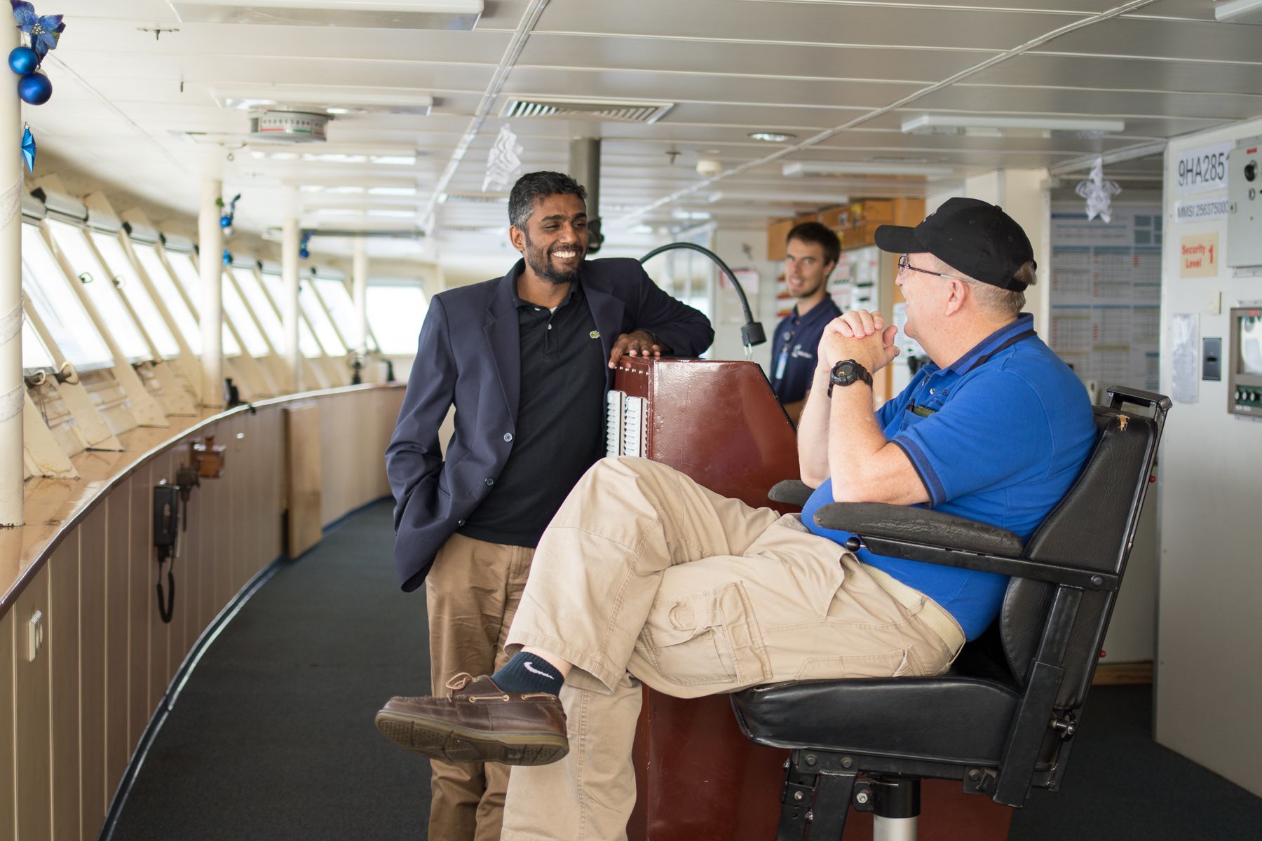 At Sea :: Logos Hope's Captain Tom Dyer (USA) and Director Seelan Govender (South Africa) talk on the Bridge.