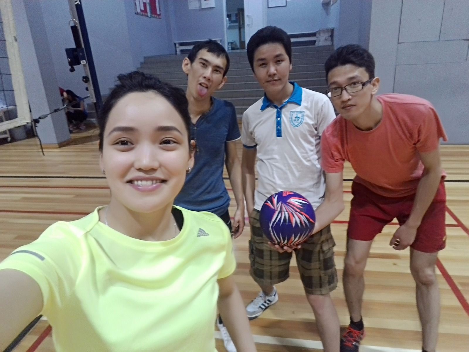 Central Asian young people on an indoor volleyball court