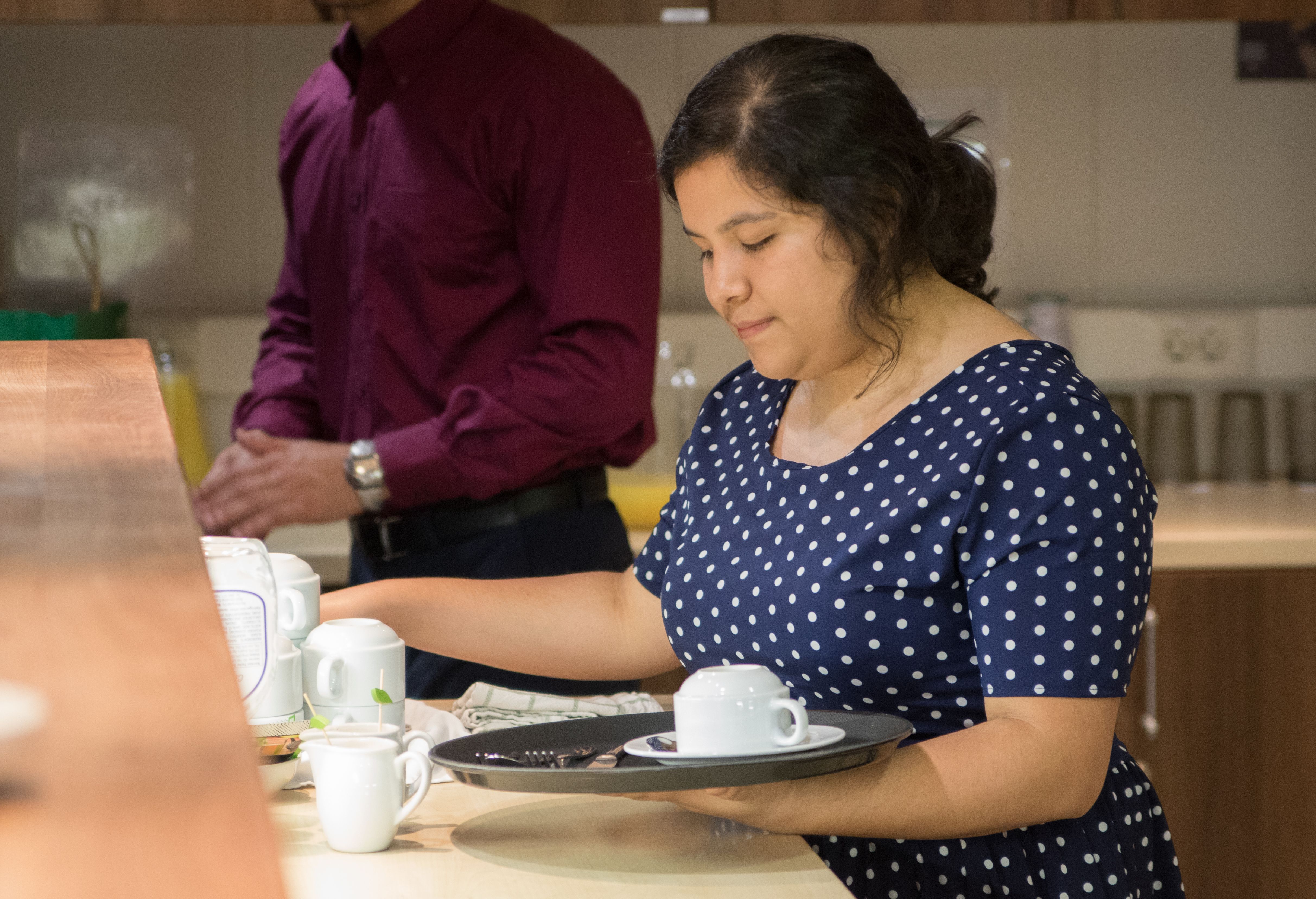 Port of Spain, Trinidad and Tobago :: Valeria Balderas (Mexico) prepares tea at an event.