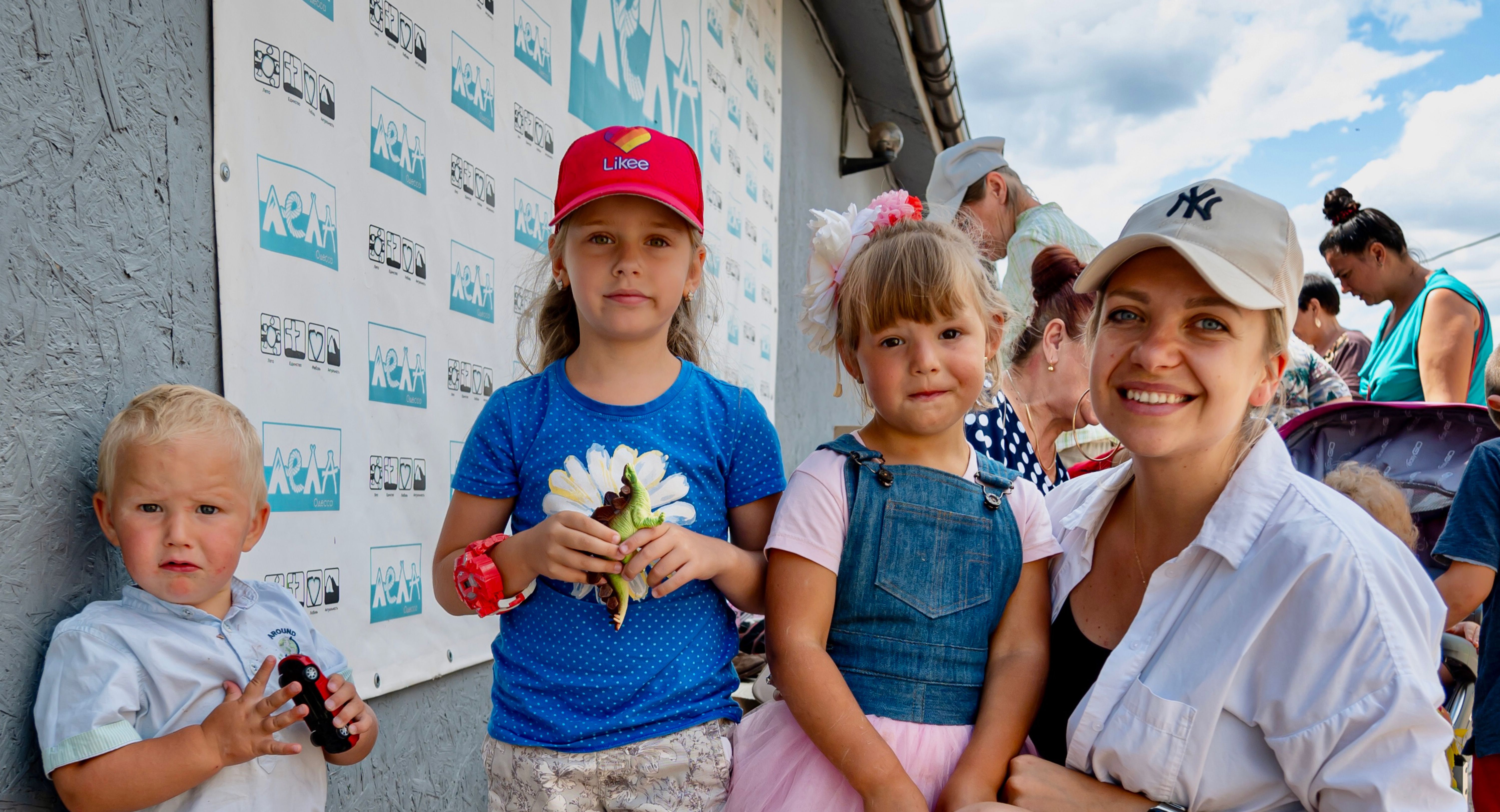 A young family outside a church giving out supplies. Photo by Alex Coleman.