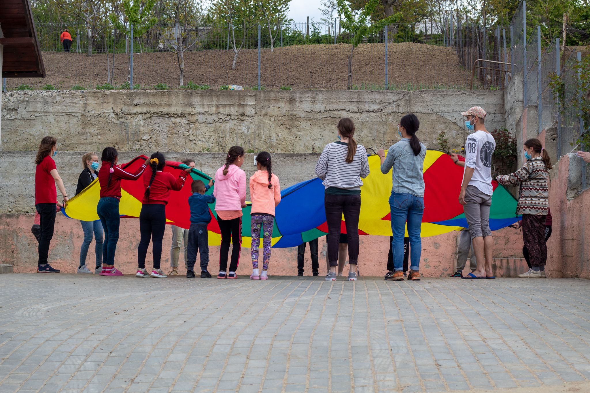Participants of REACH in Moldova and Romania playing with children while on an outreach in Moldova.