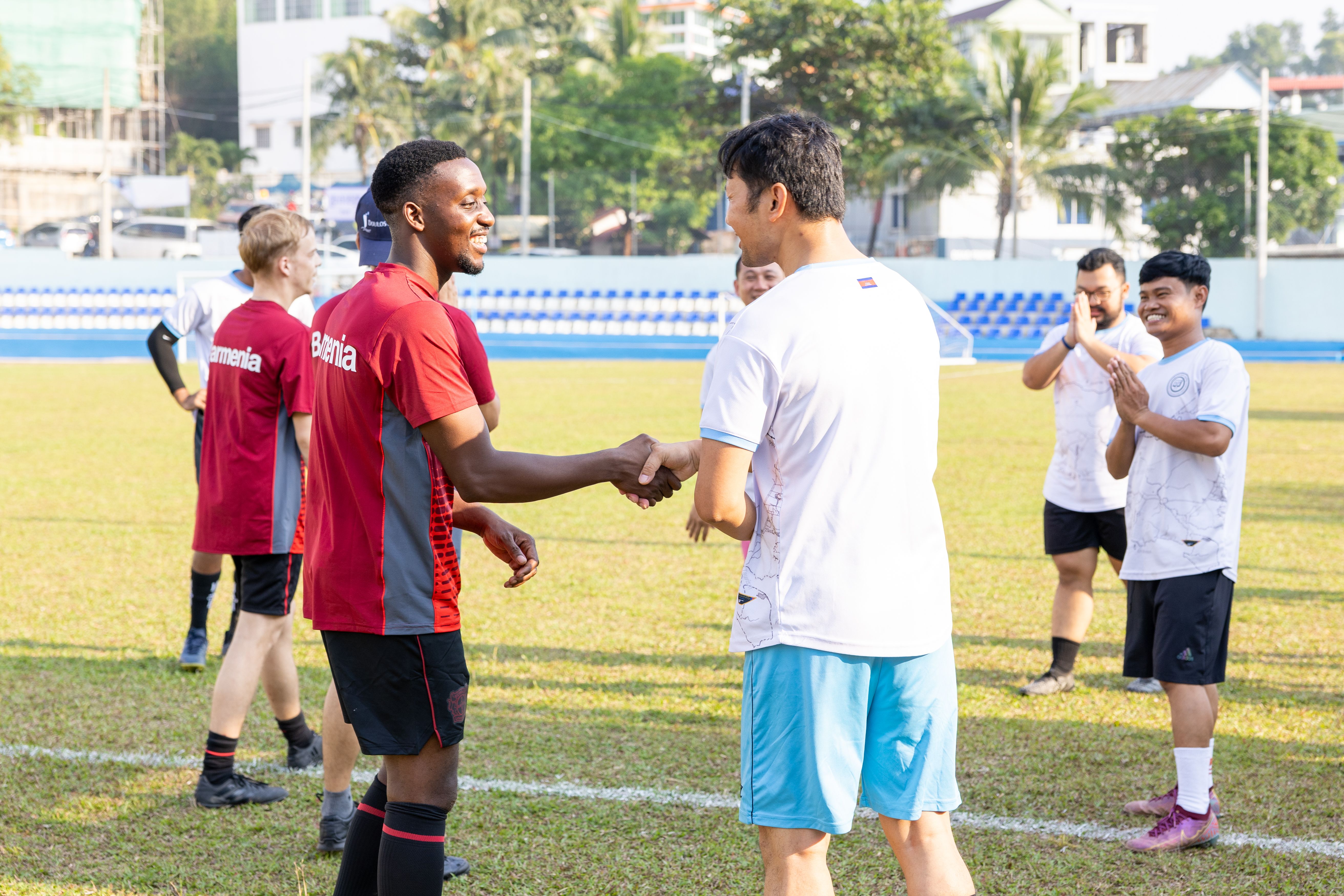 Sihanoukville, Cambodia :: Bax (Zambia) talks with a player of the local team