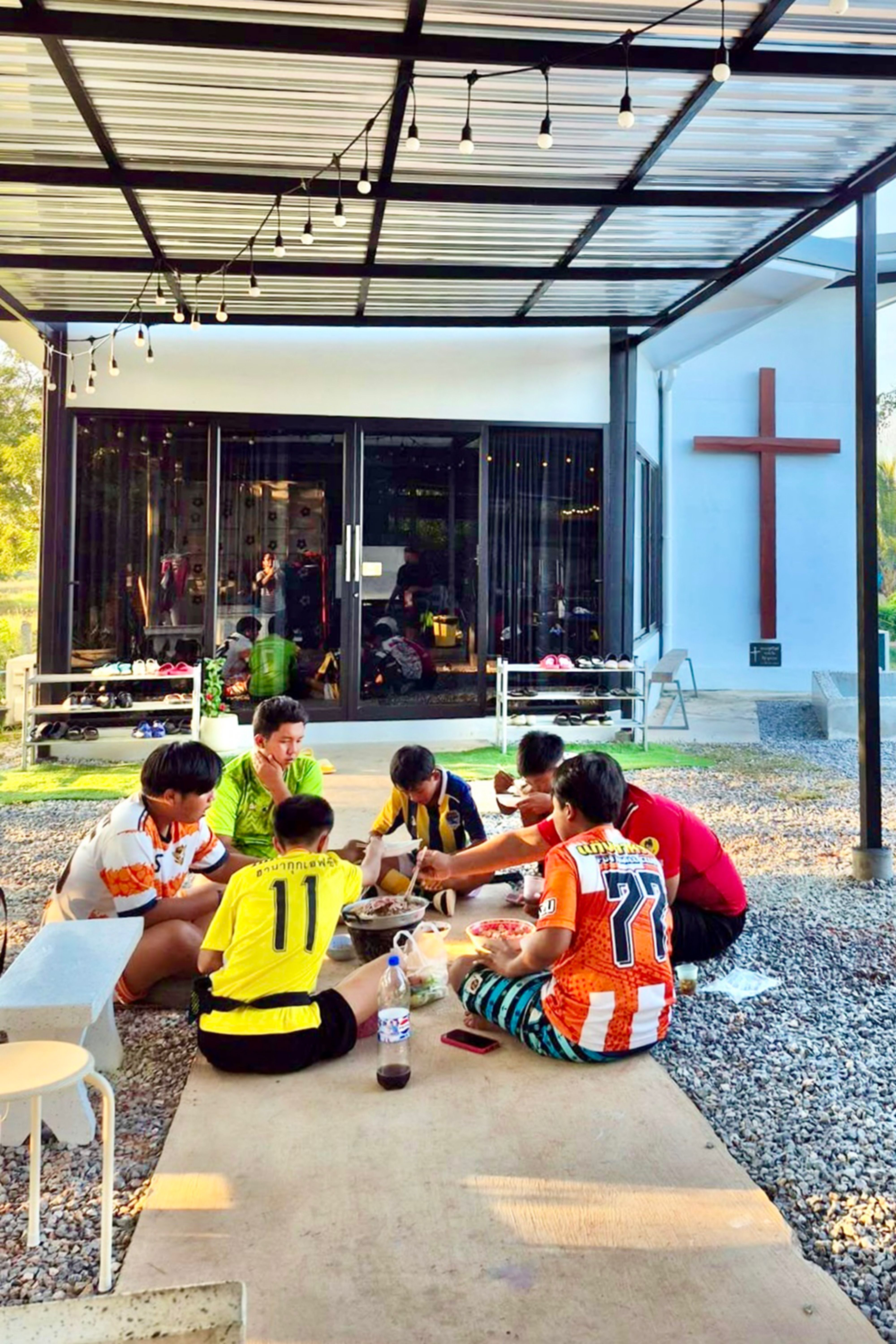 The children having meal together after the sport practice.
