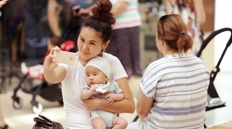 Technology is transforming Central Asia. A young mom snaps a selfie during a shopping trip at a local mall. Photo by Jay