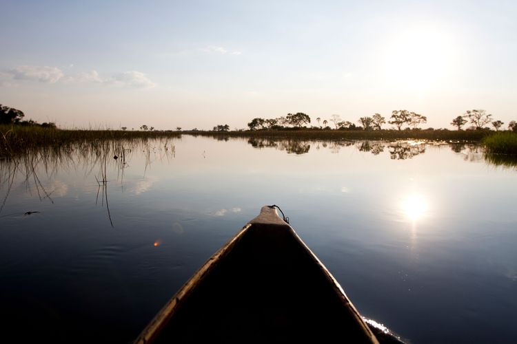 A canoe paddles on a lake.