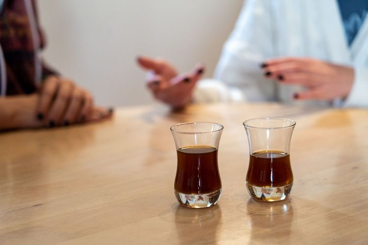 Two young women build friendships over tea. Photo by Rebecca Rempel.