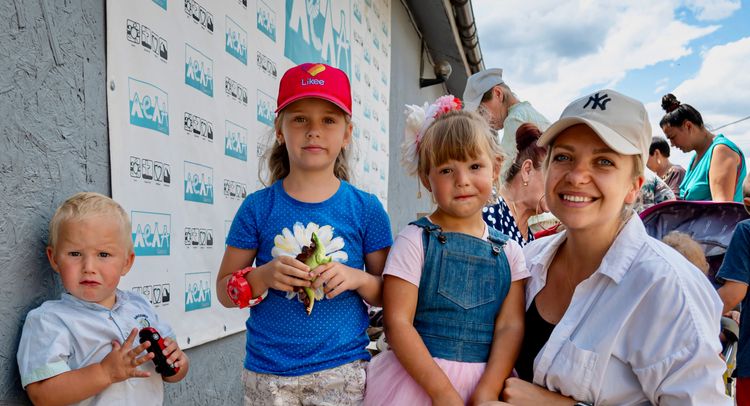 A young family outside a church giving out supplies. Photo by Alex Coleman.
