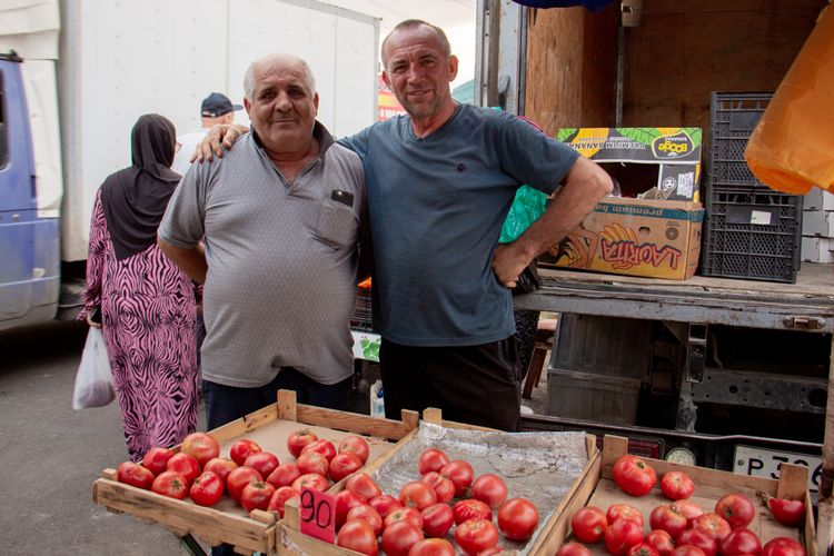 Two men pose at the market in the North Caucasus.