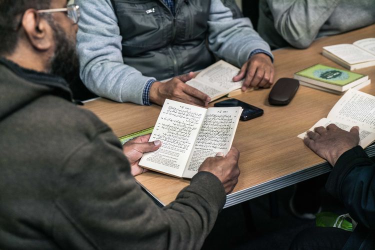 A group of men read the Bible in Arabic together. Photo by James Blake.