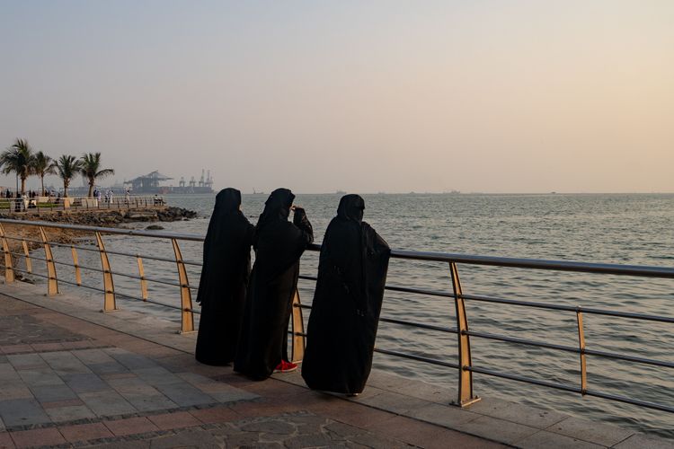 Three women watch the sunset. Photo by RJ Rempel.