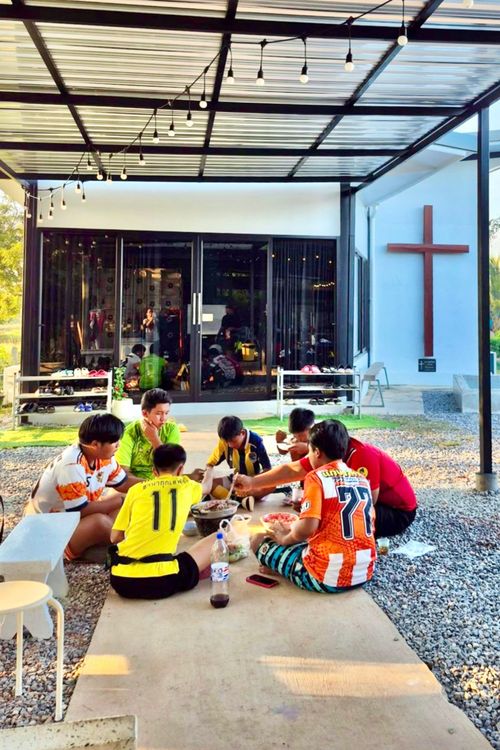 The children having meal together after the sport practice.
