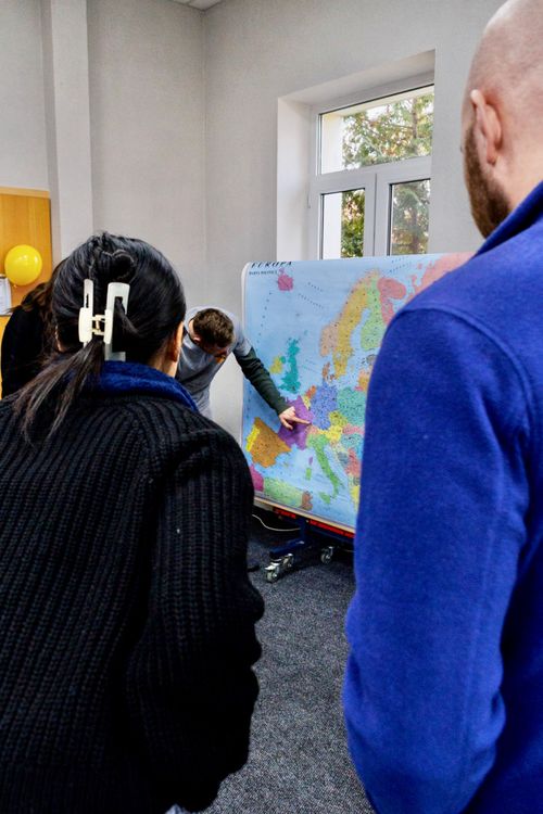 A REACH staff member points at a map. Photo by Jordan Wilkinson.