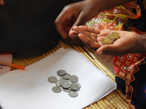 One Self Help Group at Lake Tanganyika collecting money they saved throughout the week to help themselves get out of the poverty.