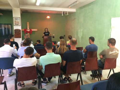 A participant of the travelling discipleship ministry (Journey to the North) shares her testimony in a local church in northern Albania.