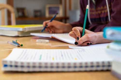Two young women do their homework. Photo by Rebecca Rempel.