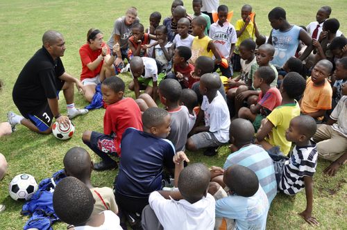 Encouraging school children during a break of soccer training in Zambia.