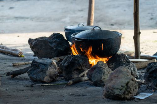 Food is prepared over a fire in a village in Sierra Leone. Photo by RJ Rempel.