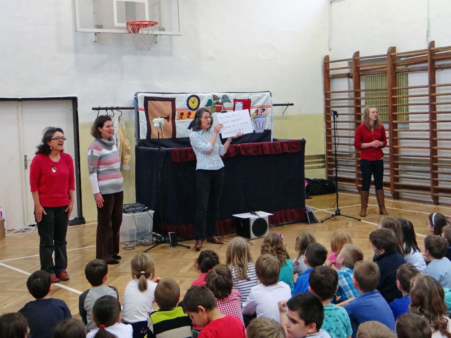 The OM Hungary puppet ministry team leads schoolchildren in a song during the team's annual Christmas outreach.