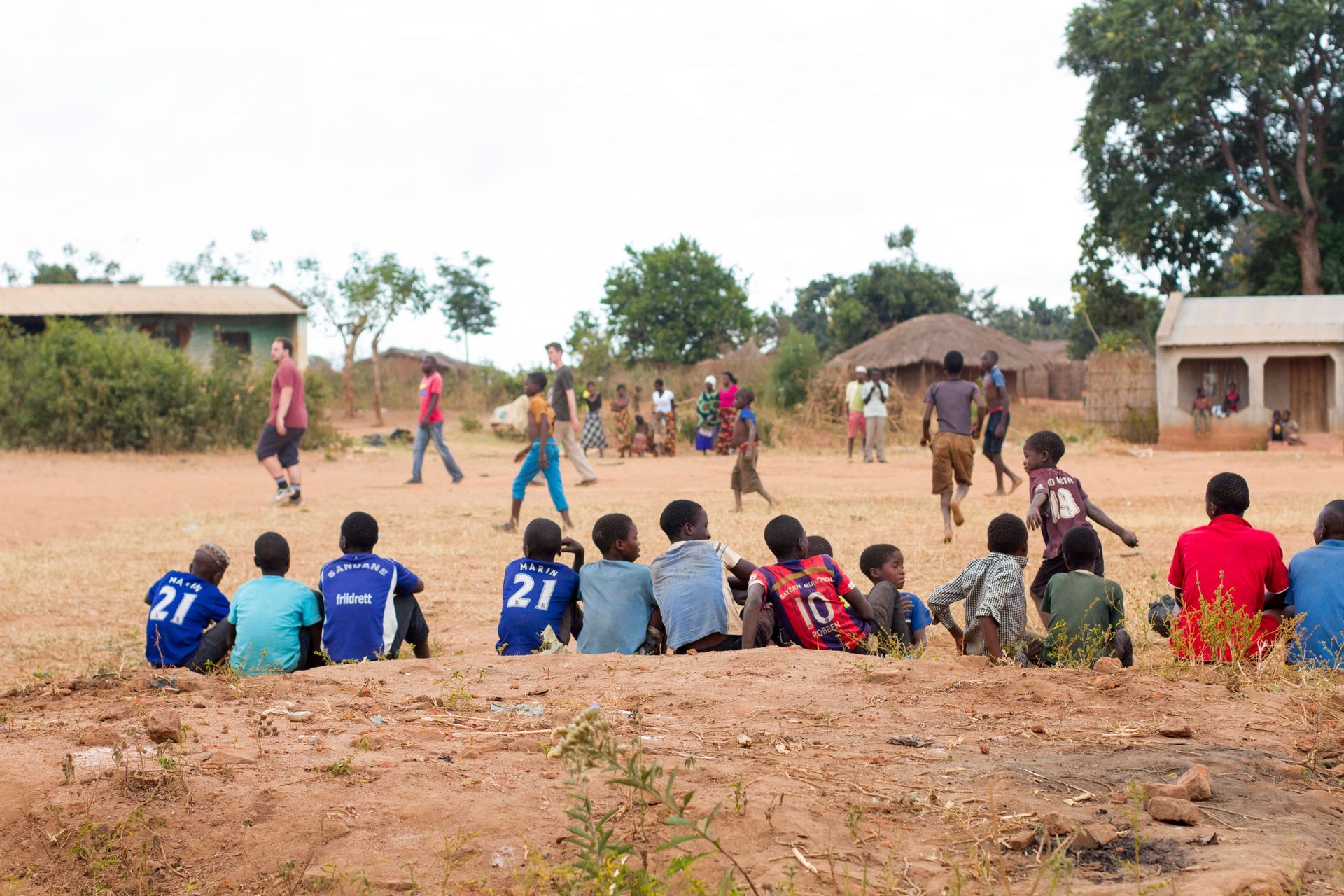 Bystanders watch a soccer game put on by the Africa Trek on outreach.