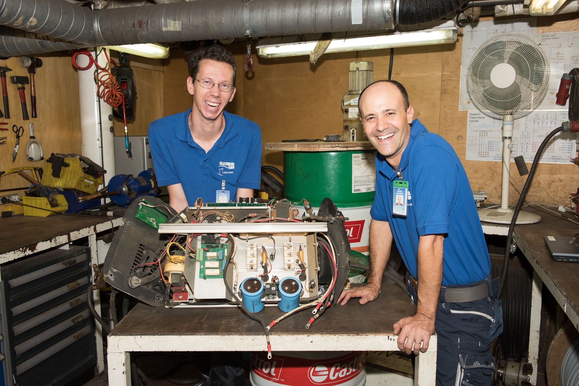 Montego Bay, Jamaica :: Bill Zollinger (Switzerland) and Daniel Espósito (Argentina) work on a project in the electricians' workshop.