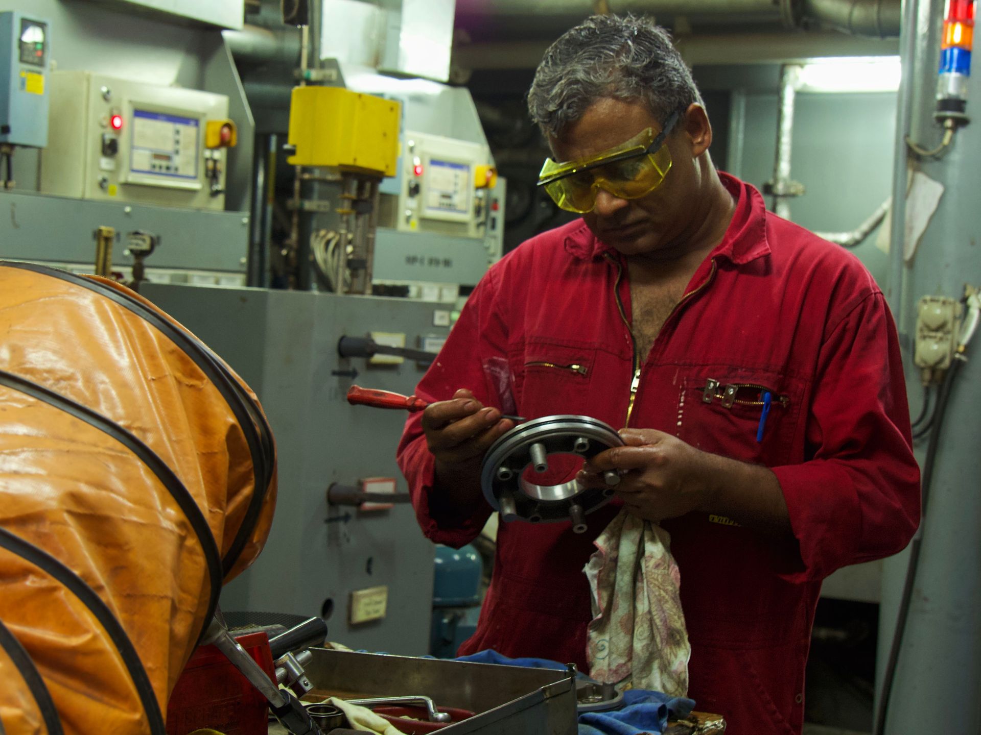 Veracruz, Mexico :: Prakash Anil (India) works on a machine part in the engine room.