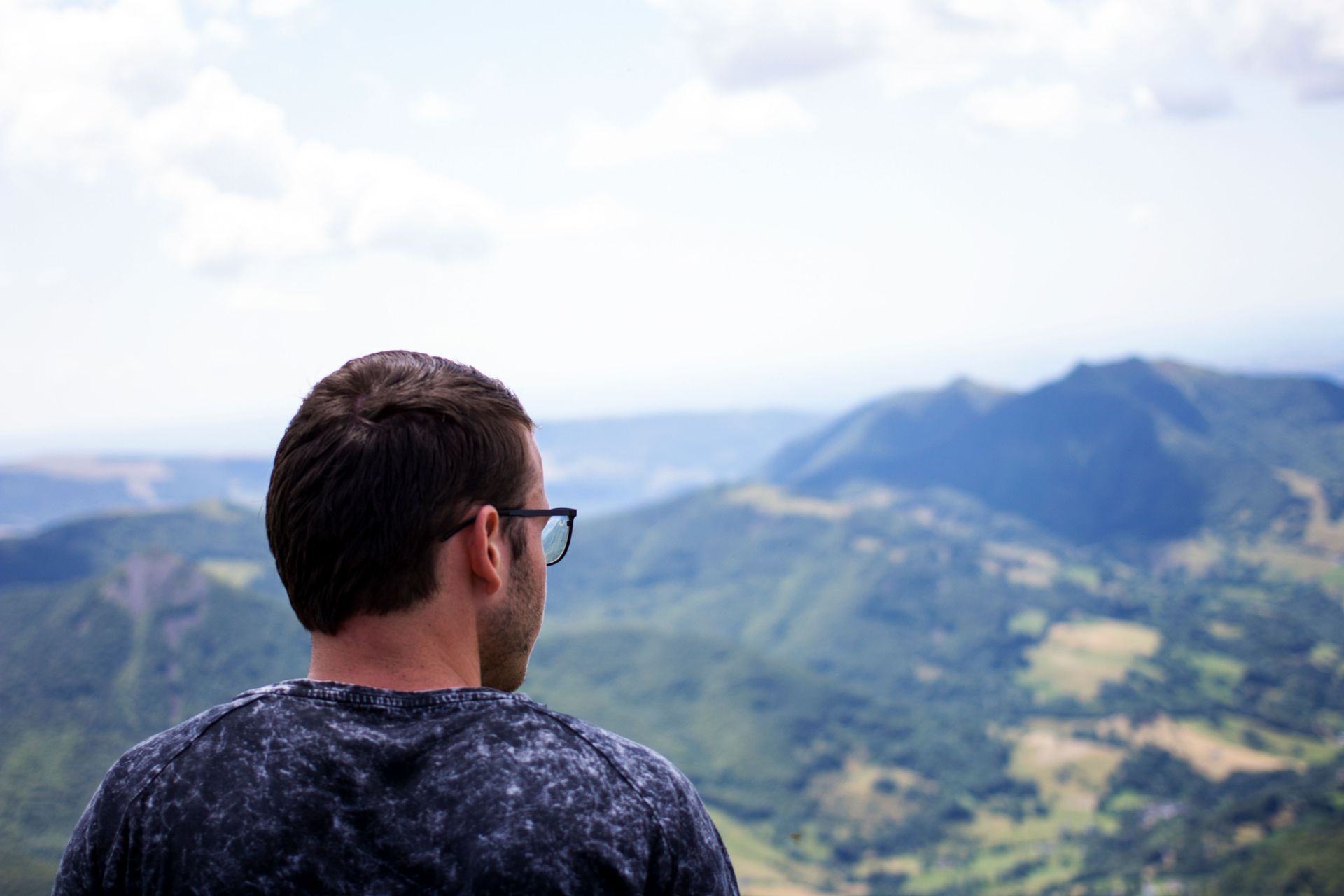 Norwegian young man sits and stares at God's creation on top of Puy Mary in the Cantal Region of France.