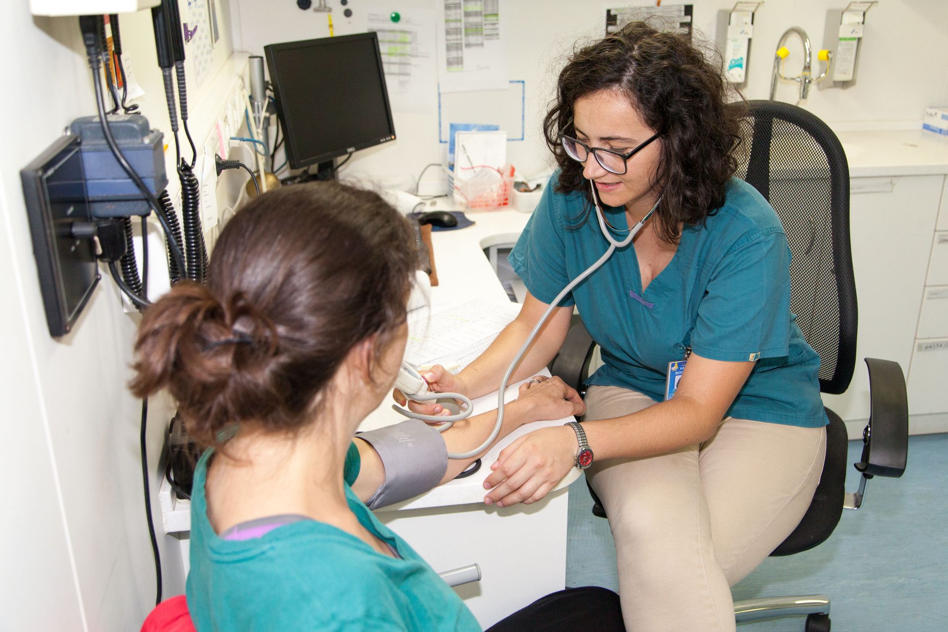 At Sea :: Nurse Katia Bodareva (Moldova) measures a crewmember's blood pressure.