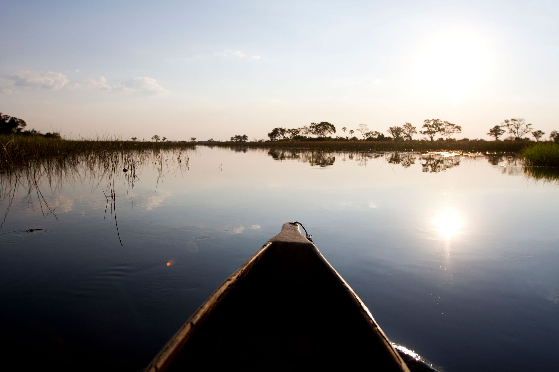 A canoe paddles on a lake.