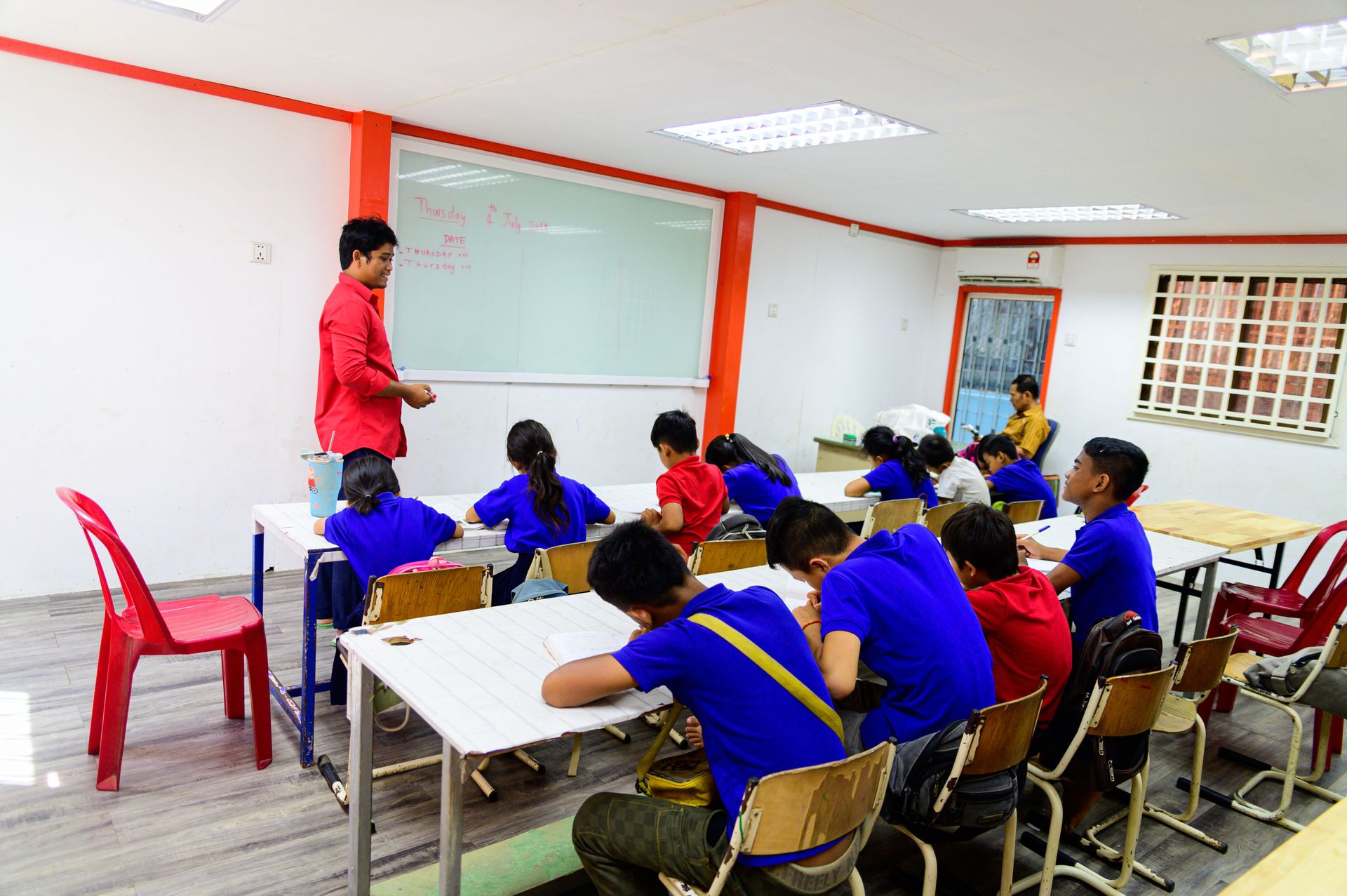 A school run by the team in Cambodia, this class is taking place in the new school building built from shipping containers.