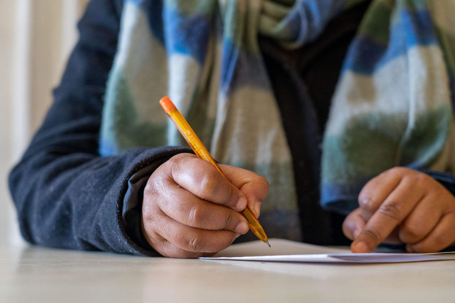 Hands writing. Photo by Rebecca Rempel.