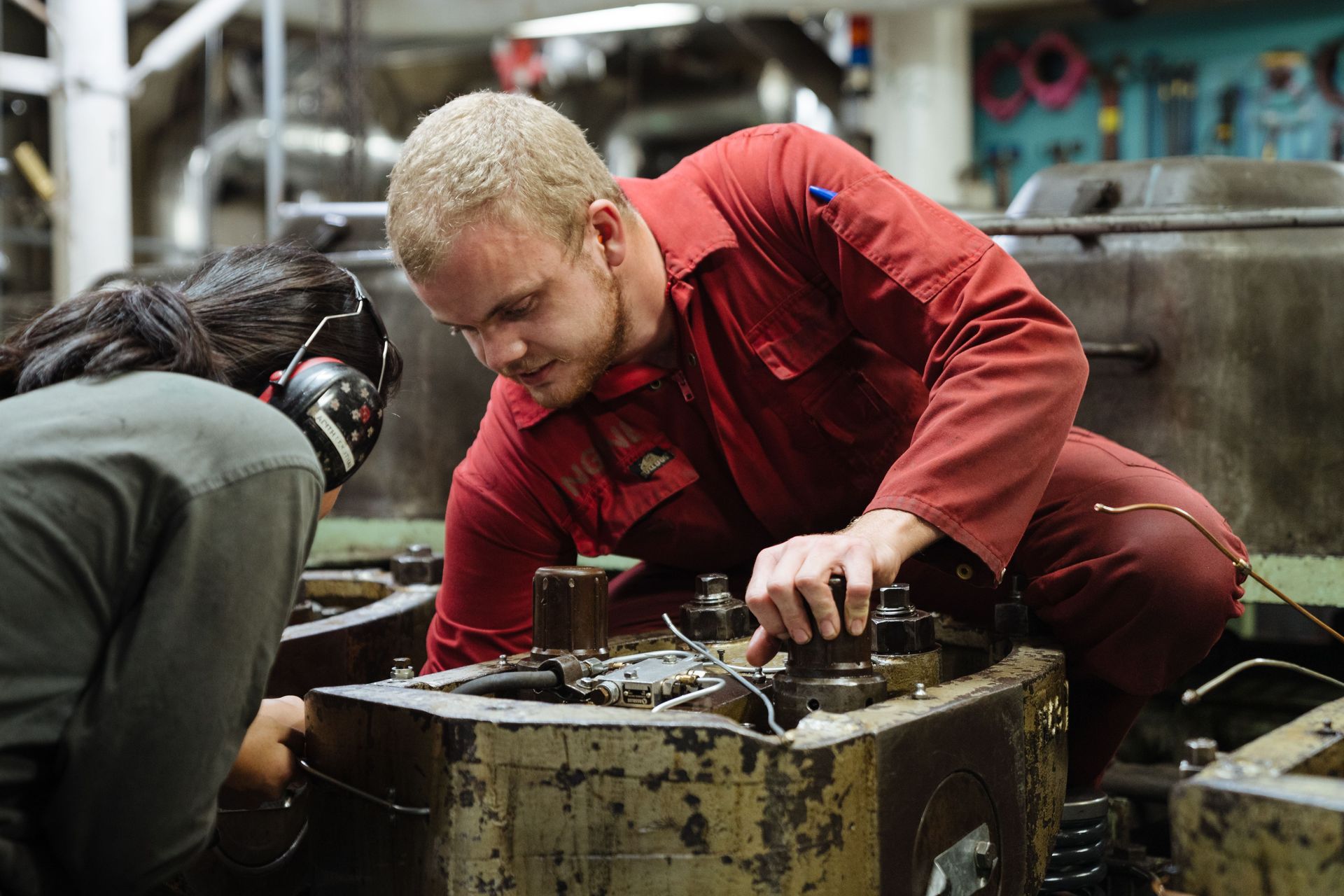 Freetown, Sierra Leone :: Logos Hope's Third Engineer, Jonathan Sortland (Norway), works with another crewmember in the engine room.