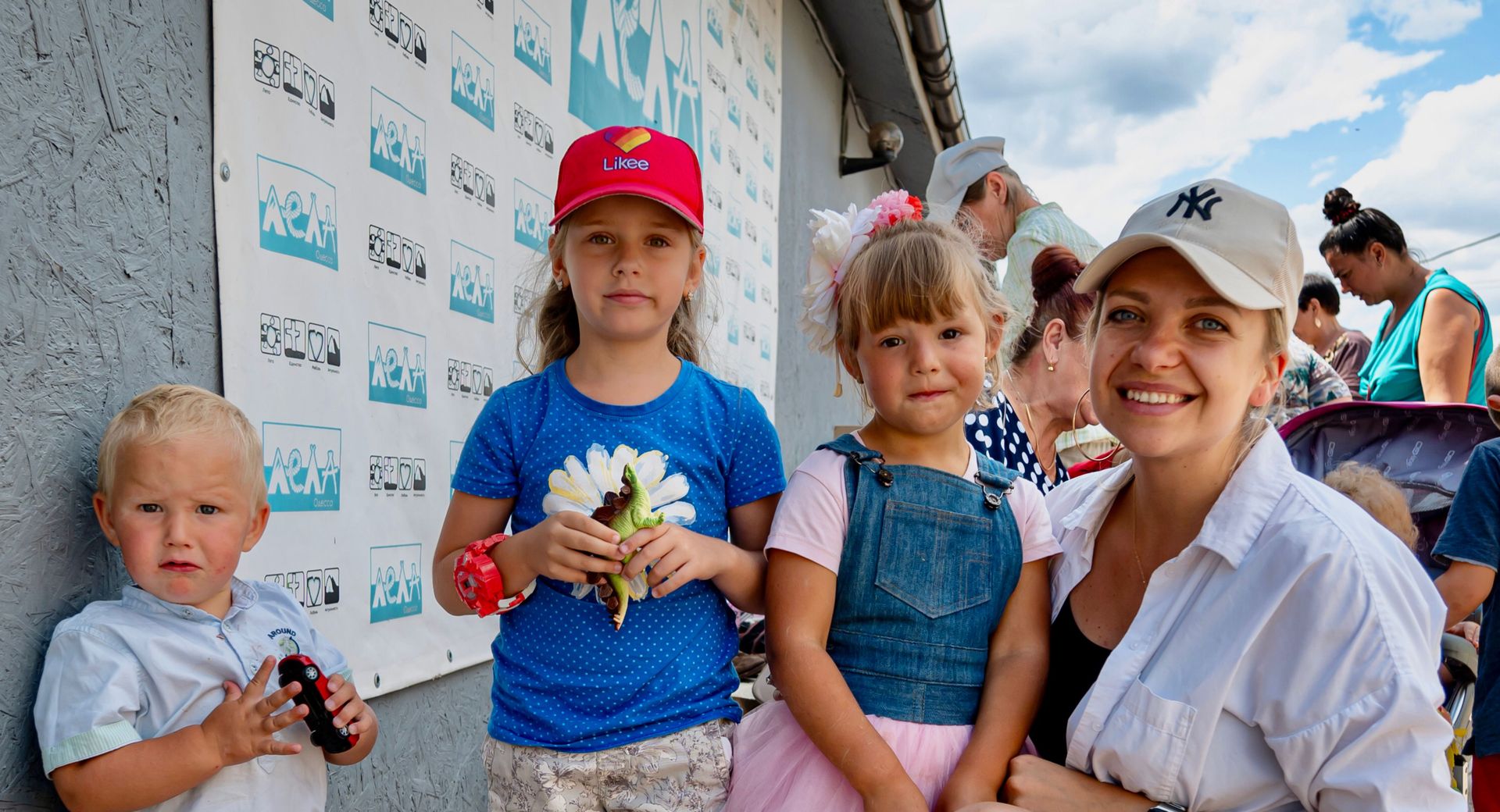 A young family outside a church giving out supplies. Photo by Alex Coleman.