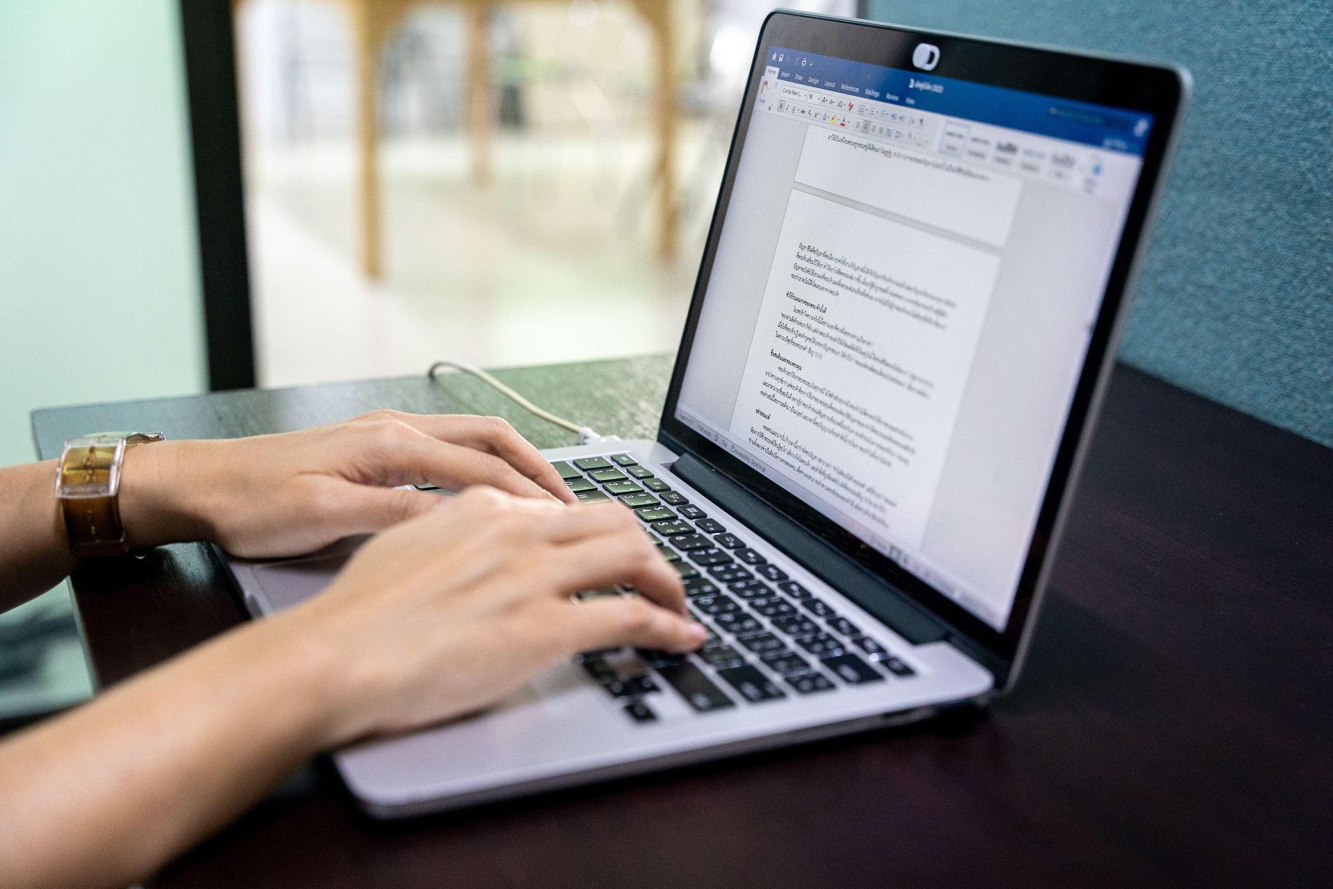 Hands typing on a Thai keyboard. Photo by RJ Rempel.