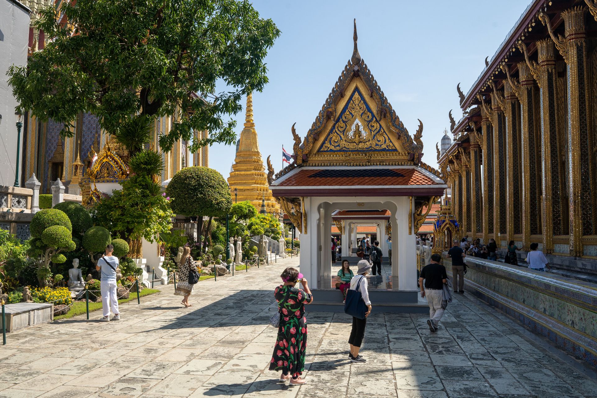 Tourists visit the temple complex at The Grand Palace in Bangkok, Thailand. Photo by RJ Rempel.