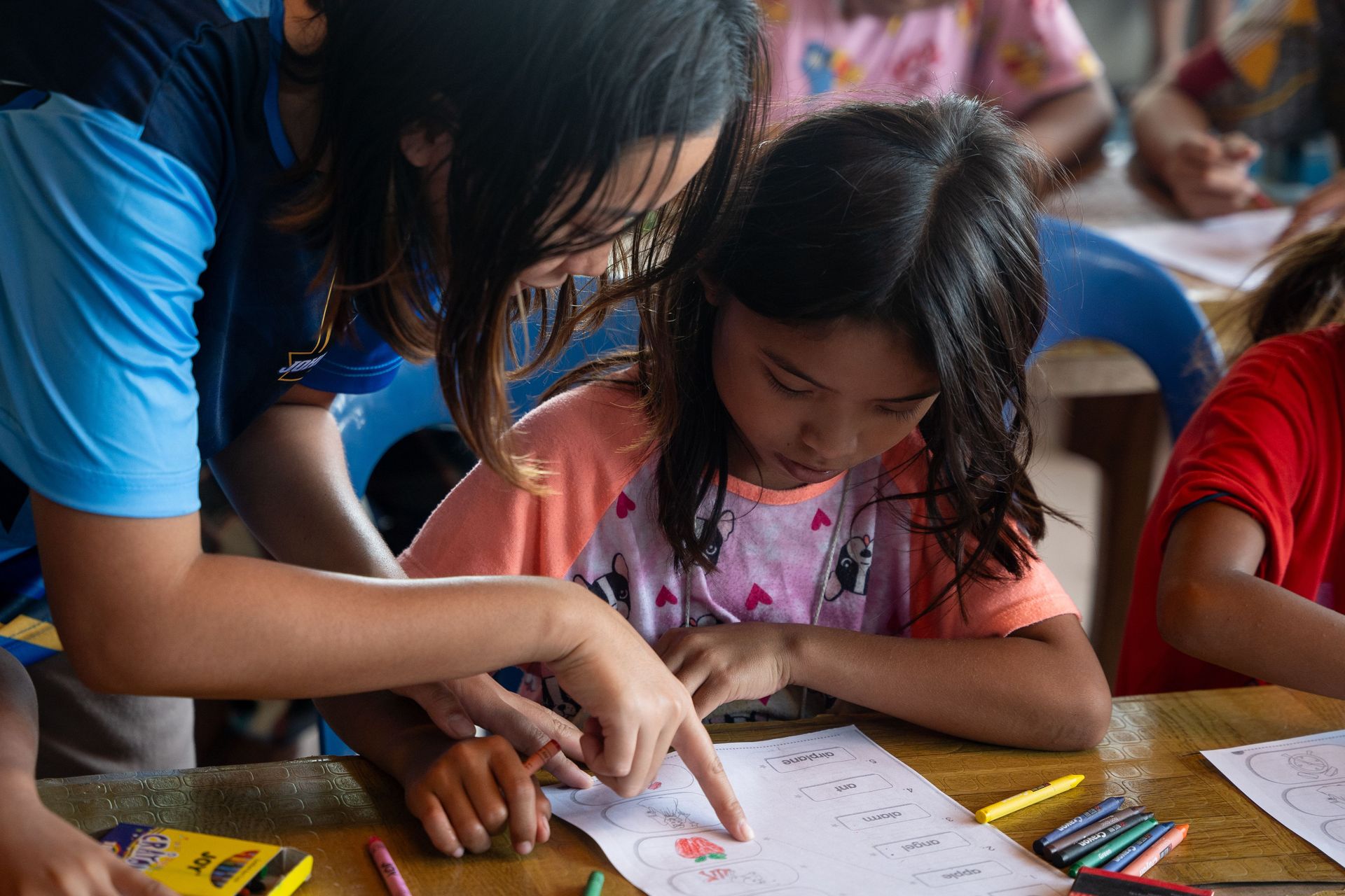 A teacher helps a student with an assignment at the Tutorial Centre. Photo by RJ Rempel.