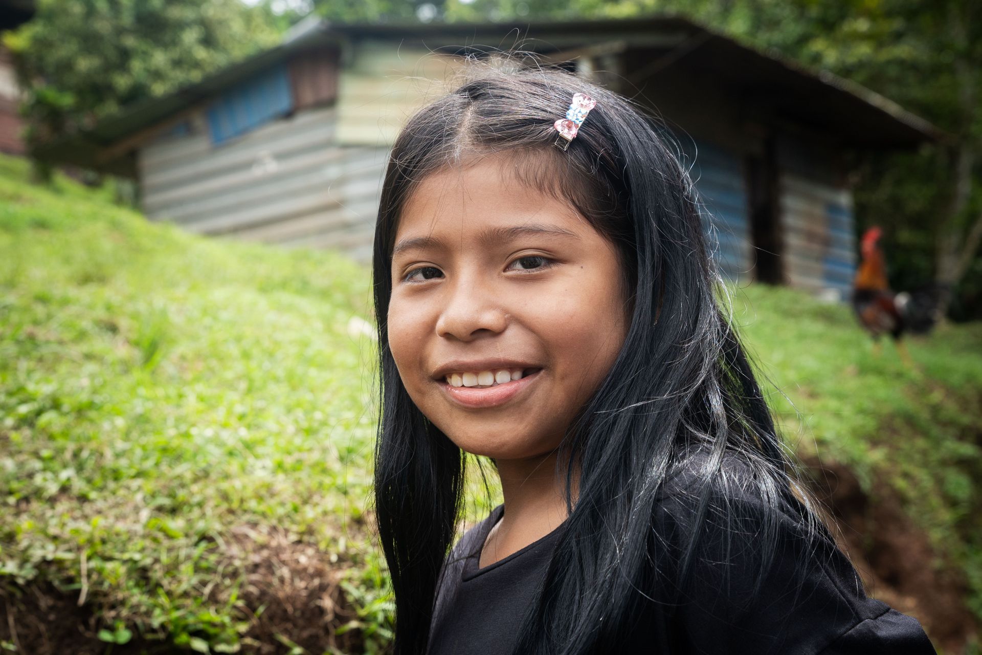 A girl smiles for a photo. Photo by RJ Rempel.