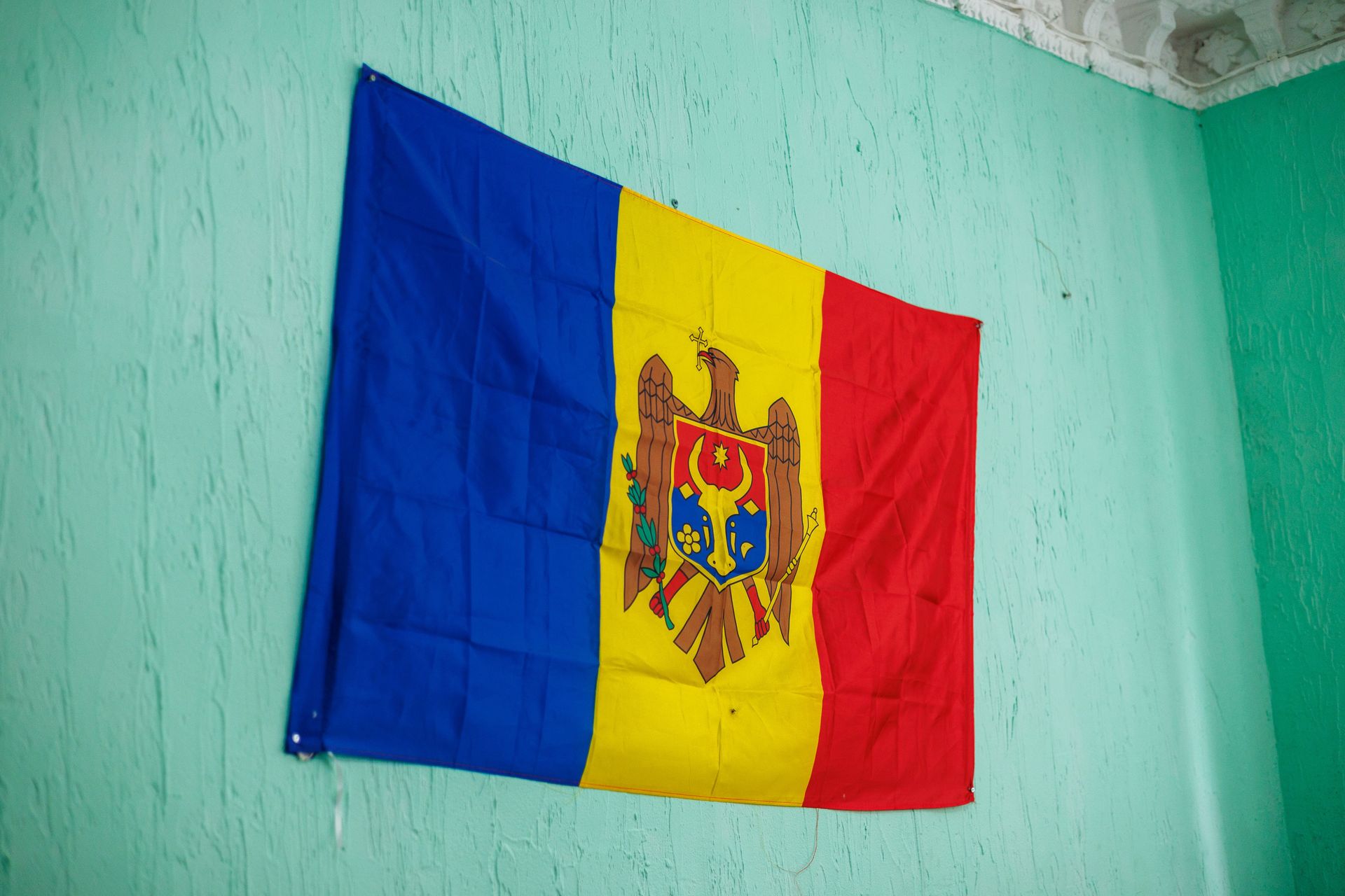 A Moldovan flag hanging inside a building. Photo by Jordan Wilkinson.