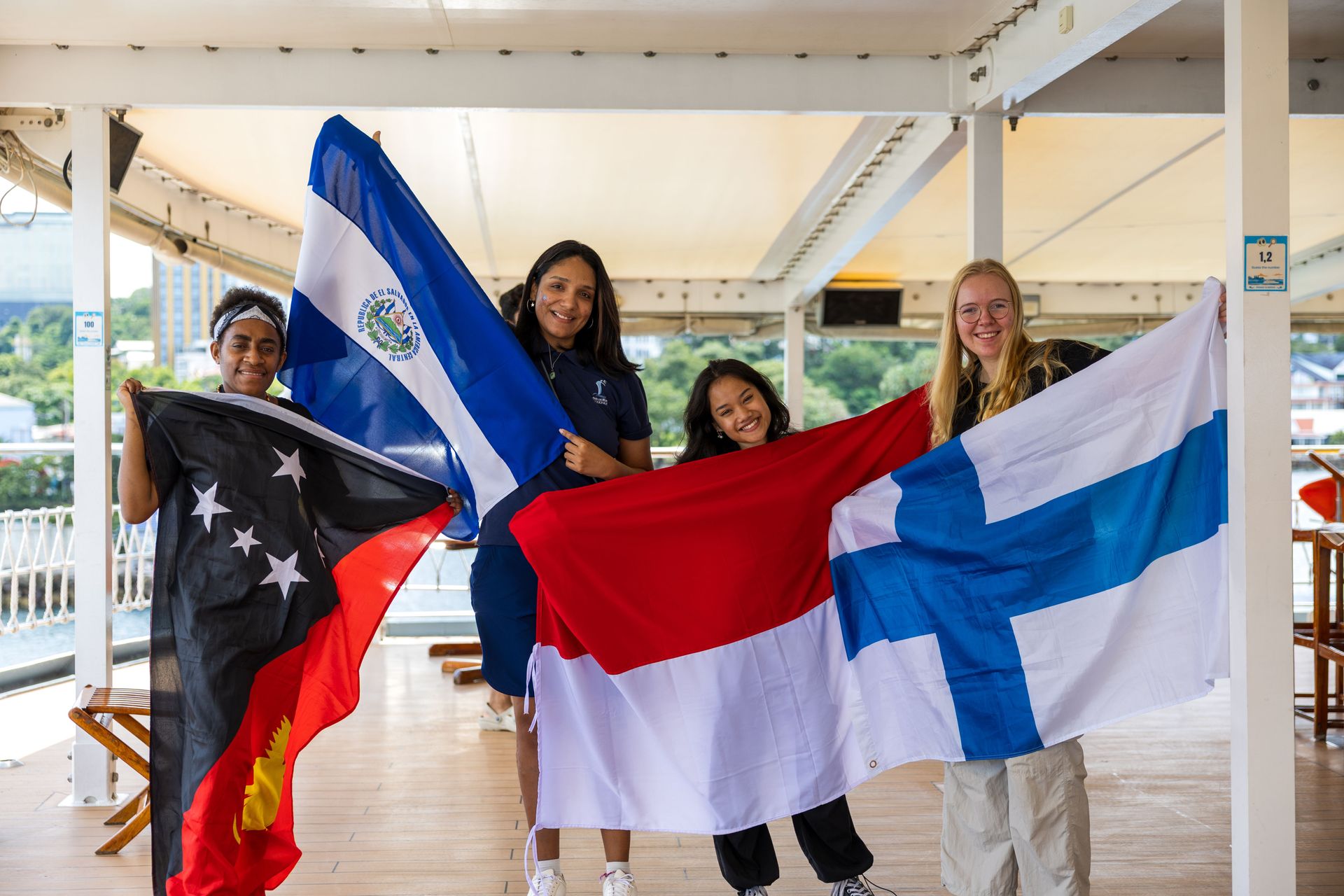 Sihanoukville, Cambodia :: Crewmembers poses with their flags upon Doulos Hope’s arrival to the port.